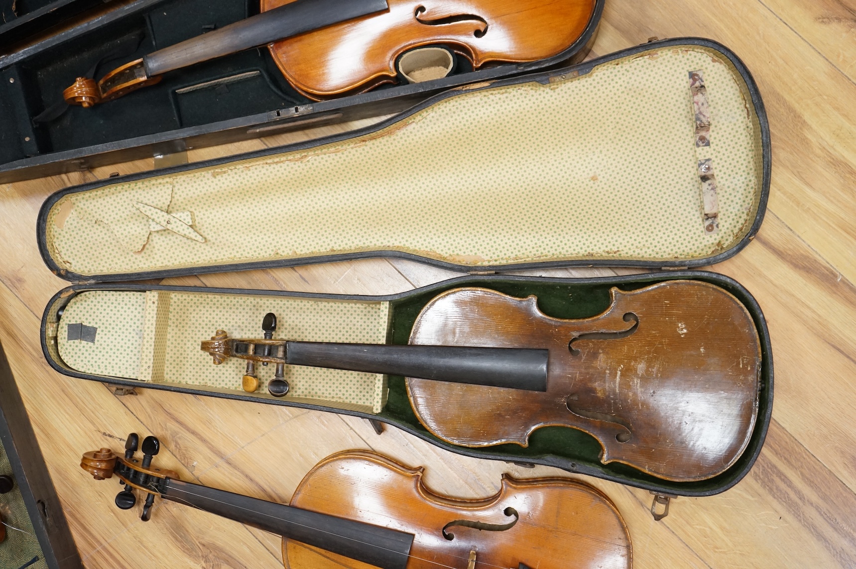 Four violins; a German Dresden violin, together with further two German violins, and a Saxony violin, three in cases or the remains of cases.